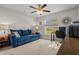Inviting living room featuring a comfortable couch, a window, and a ceiling fan at 7886 Sw 103Rd Loop, Ocala, FL 34476