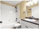 Bright bathroom featuring a shower-tub combo, white tile, and modern vanity with a granite countertop at 8 Hemlock Radl, Ocala, FL 34472