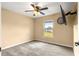 Neutral bedroom featuring a ceiling fan and natural light with a view outside at 8 Hemlock Radl, Ocala, FL 34472