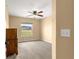 Neutral bedroom with plush carpeting, ceiling fan and a window that allows for lots of natural light at 8 Hemlock Radl, Ocala, FL 34472