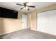 Relaxing bedroom featuring a ceiling fan and closet doors for storage at 8 Hemlock Radl, Ocala, FL 34472