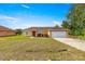Charming single-story home with a well-maintained front lawn, and a two car garage at 8 Hemlock Radl, Ocala, FL 34472