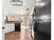 Kitchen view showcasing modern appliances and cabinetry, and an opening to a carpeted living room at 8 Hemlock Radl, Ocala, FL 34472