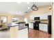 Well-equipped kitchen with white cabinets, modern appliances, and wood-look flooring at 8 Hemlock Radl, Ocala, FL 34472