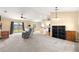 Bright open-plan living room with modern carpet, ceiling fan, and plenty of natural light at 8 Hemlock Radl, Ocala, FL 34472