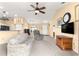 An inviting living room showcasing carpeted floors, ceiling fan, comfortable furnishings and a TV at 8 Hemlock Radl, Ocala, FL 34472