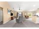 Spacious living room featuring neutral carpet, ceiling fan, and comfortable furnishings at 8 Hemlock Radl, Ocala, FL 34472
