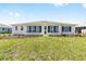 Lush backyard featuring green lawn and mulched flower beds, surrounded by similar homes at 8497 Sw 99Th Cir, Ocala, FL 34481