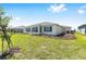 Backyard featuring lush green lawn and mulched flowerbeds with trees surrounding the perimeter at 8497 Sw 99Th Cir, Ocala, FL 34481