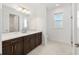 Modern bathroom features a long vanity with white countertop and dark cabinets at 8497 Sw 99Th Cir, Ocala, FL 34481