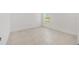 Bright, tile-floored bedroom with natural light streaming through the window, creating a peaceful retreat at 8497 Sw 99Th Cir, Ocala, FL 34481