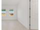 Bright bedroom with two windows, neutral walls and tile floors, offering a comfortable and versatile space at 8497 Sw 99Th Cir, Ocala, FL 34481