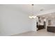 Dining room featuring a chandelier, with a partial view of the modern kitchen at 8497 Sw 99Th Cir, Ocala, FL 34481