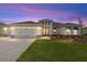 Charming single-story home features a three-car garage, well-manicured lawn, and covered entryway at 8497 Sw 99Th Cir, Ocala, FL 34481