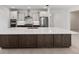 Modern kitchen featuring stainless steel appliances, a large island, and elegant white and brown cabinetry at 8497 Sw 99Th Cir, Ocala, FL 34481