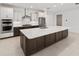 Spacious kitchen showcasing a large island with seating, stainless steel appliances, and contemporary cabinetry at 8497 Sw 99Th Cir, Ocala, FL 34481