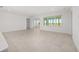 Open-concept living room with neutral tile flooring, bright natural light, and contemporary finishes at 8497 Sw 99Th Cir, Ocala, FL 34481