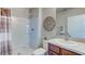 A bathroom featuring a walk-in shower, vanity with sink, neutral-toned walls and brown decorative accents at 8626 Sw 44Th Ter, Ocala, FL 34476