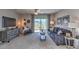 Cozy living room with a plush sofa, modern decor, and a sliding glass door leading to the backyard at 8626 Sw 44Th Ter, Ocala, FL 34476