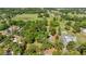 Aerial view showcasing a large, tree-filled property, with a clear boundary marked in red and surrounded by greenery at 8630 Sw 20Th Ct, Ocala, FL 34476