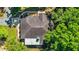 Overhead view of a well-maintained roof surrounded by lush greenery and a charming walkway at 8630 Sw 20Th Ct, Ocala, FL 34476