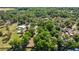 Wide aerial shot showcasing a large, tree-covered property within a serene and natural landscape at 8630 Sw 20Th Ct, Ocala, FL 34476
