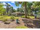 Backyard view shows a large yard with mature landscaping and access to the screened-in sunroom at 8630 Sw 20Th Ct, Ocala, FL 34476
