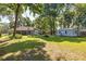 Sprawling backyard featuring lush lawn, mature trees, and a detached shed, perfect for outdoor enjoyment at 8630 Sw 20Th Ct, Ocala, FL 34476