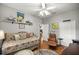 This bedroom includes wood floors, white trim, and chair at 8630 Sw 20Th Ct, Ocala, FL 34476