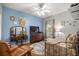 This bedroom features a ceiling fan, wood floors, and natural light at 8630 Sw 20Th Ct, Ocala, FL 34476