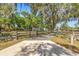 Gated driveway leading to a beautiful property with mature trees at 8630 Sw 20Th Ct, Ocala, FL 34476