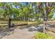 Wrought iron gate at the entrance to the long driveway of this secluded property, surrounded by mature trees at 8630 Sw 20Th Ct, Ocala, FL 34476