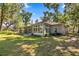 Exterior home view displays the large sunroom with plenty of natural light and backyard access at 8630 Sw 20Th Ct, Ocala, FL 34476