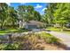 Charming home with a screened garage and driveway nestled amongst mature trees and landscaping at 8630 Sw 20Th Ct, Ocala, FL 34476