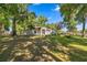 Single-story home featuring a large lawn and mature trees providing ample shade at 8630 Sw 20Th Ct, Ocala, FL 34476