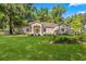 Charming single-story home with a manicured front lawn and mature trees in a peaceful setting at 8630 Sw 20Th Ct, Ocala, FL 34476