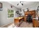 Well-lit home office featuring a large wooden desk and functional built-in storage at 8630 Sw 20Th Ct, Ocala, FL 34476