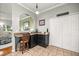 Kitchen features granite counters, storage cabinets, and a view of the living room at 8630 Sw 20Th Ct, Ocala, FL 34476