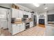 Kitchen features white cabinets, granite counters, stainless appliances, and tile flooring at 8630 Sw 20Th Ct, Ocala, FL 34476