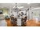 Bright kitchen featuring white cabinets, granite counters, stainless appliances, and a large island with seating at 8630 Sw 20Th Ct, Ocala, FL 34476