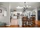 Open kitchen with island seating, featuring white cabinets, stainless appliances, and tile flooring at 8630 Sw 20Th Ct, Ocala, FL 34476
