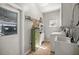 Functional laundry room featuring a washer, dryer, sink, storage cabinets, and tile flooring at 8630 Sw 20Th Ct, Ocala, FL 34476