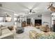 Spacious living room open floor plan featuring a fireplace, hardwood floors, and comfortable seating at 8630 Sw 20Th Ct, Ocala, FL 34476