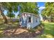 Charming outbuilding with a red star, offering additional storage or workspace in a landscaped setting at 8630 Sw 20Th Ct, Ocala, FL 34476