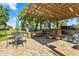 Outdoor kitchen and patio area is perfect for entertaining with an umbrella and seating at 8630 Sw 20Th Ct, Ocala, FL 34476