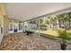 Enjoy this brick patio with screened in lanai and views of the backyard and shed at 8630 Sw 20Th Ct, Ocala, FL 34476