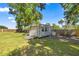 Well-maintained outdoor shed with garage door and paved driveway offers storage space at 8630 Sw 20Th Ct, Ocala, FL 34476