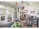 Bright sun room featuring large windows, tile flooring, and a view of the kitchen at 8630 Sw 20Th Ct, Ocala, FL 34476
