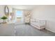 Charming Bedroom with a white crib, dresser, and a comfortable chair, all complemented by soft lighting at 8632 Sw 44Th Ter, Ocala, FL 34476