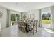Bright dining room with sliding glass doors, tile flooring, modern decor, and seating for eight at 8632 Sw 44Th Ter, Ocala, FL 34476